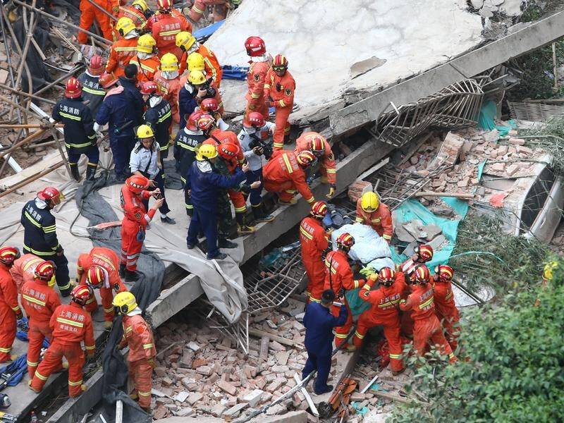 The roof of a building under renovation in Shanghai collapsed, trapping more than 20 workers.
