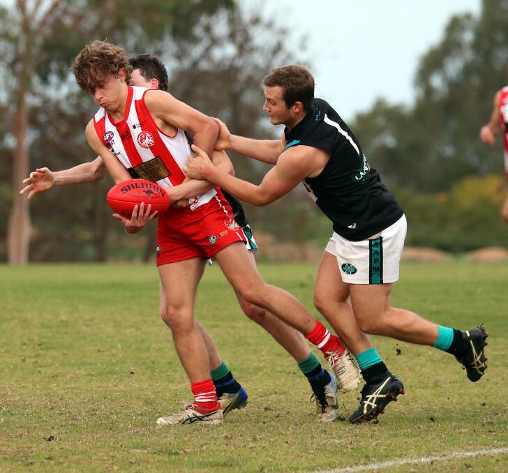 CONTEST: Harrison Drummond and Josh Avis battle it out in Farrer League football on the weekend.
