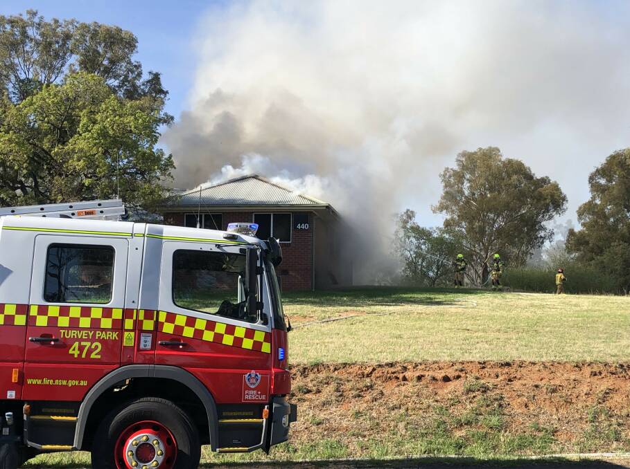 Firefighters at the scene of a building fire at Wagga's Charles Sturt University campus on Tuesday morning. Picture by Andrew Manglesdorf